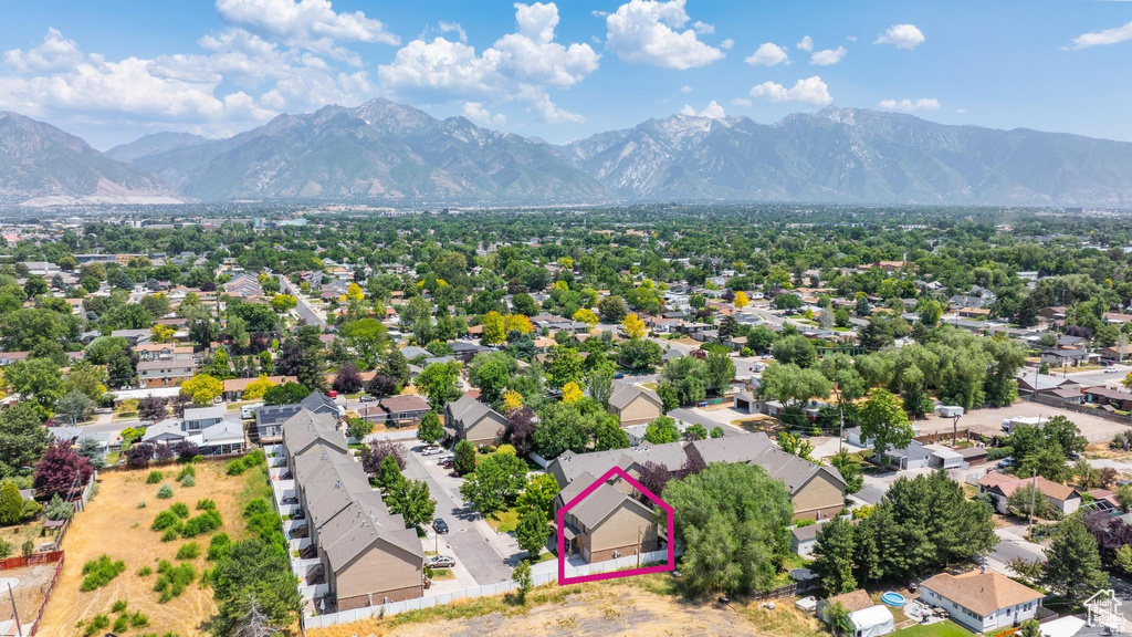 Aerial view of residential area featuring property parcel outlined and a mountainous background