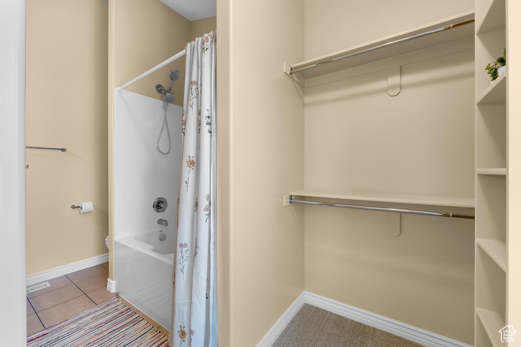 Full bathroom with shower / bath combination with curtain and tile patterned floors