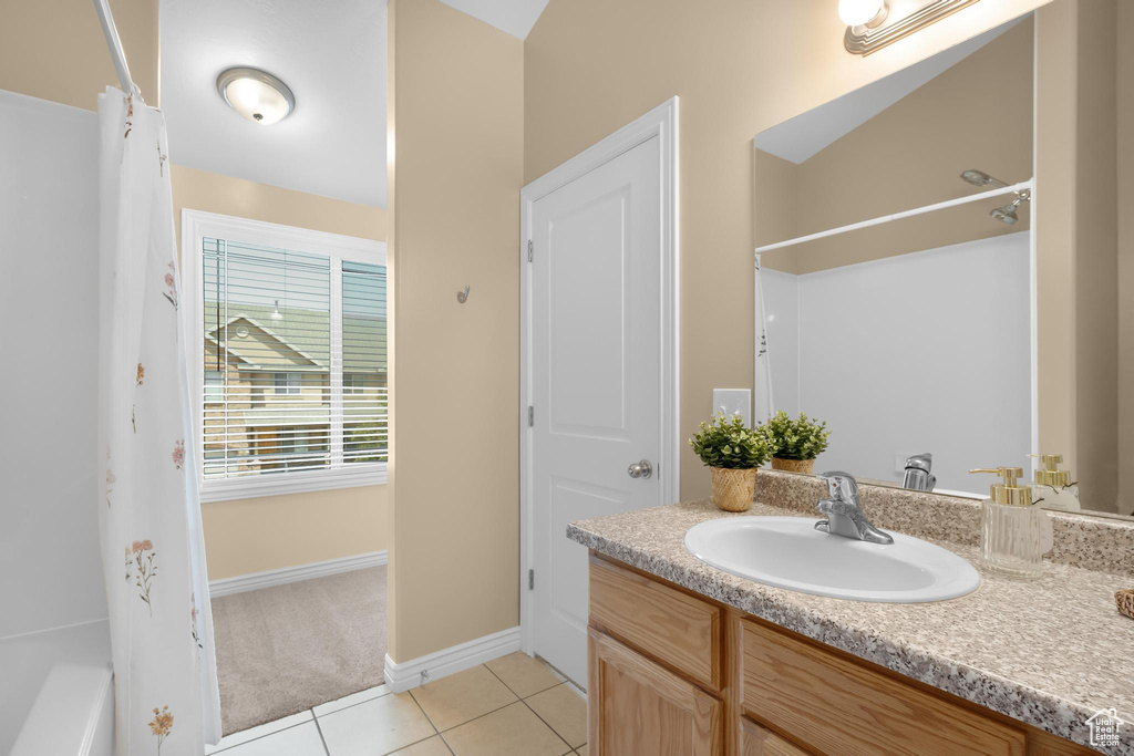 Full bath featuring vanity and tile patterned flooring