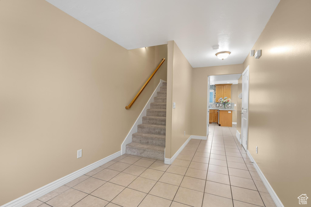 Stairs featuring tile patterned flooring and baseboards