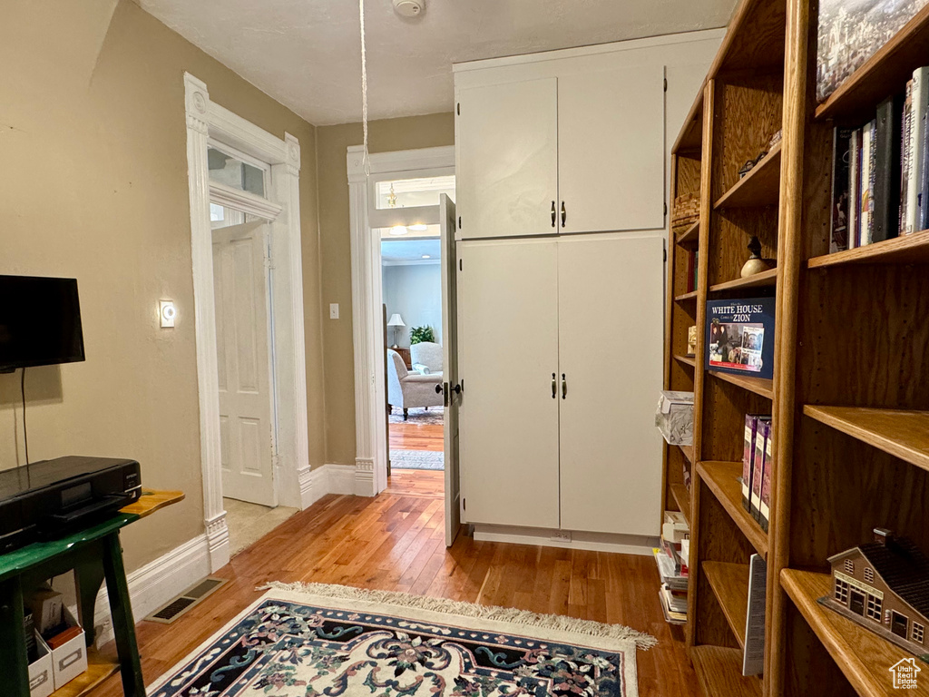 Hallway featuring light wood-style flooring