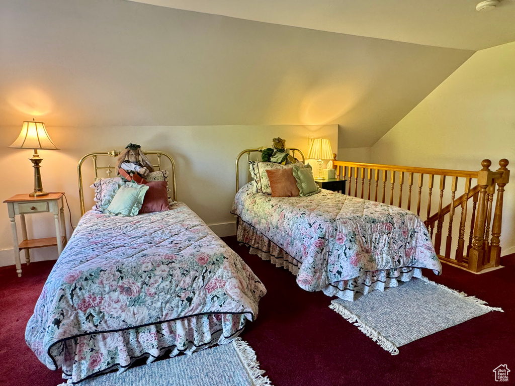 Bedroom with carpet flooring and lofted ceiling
