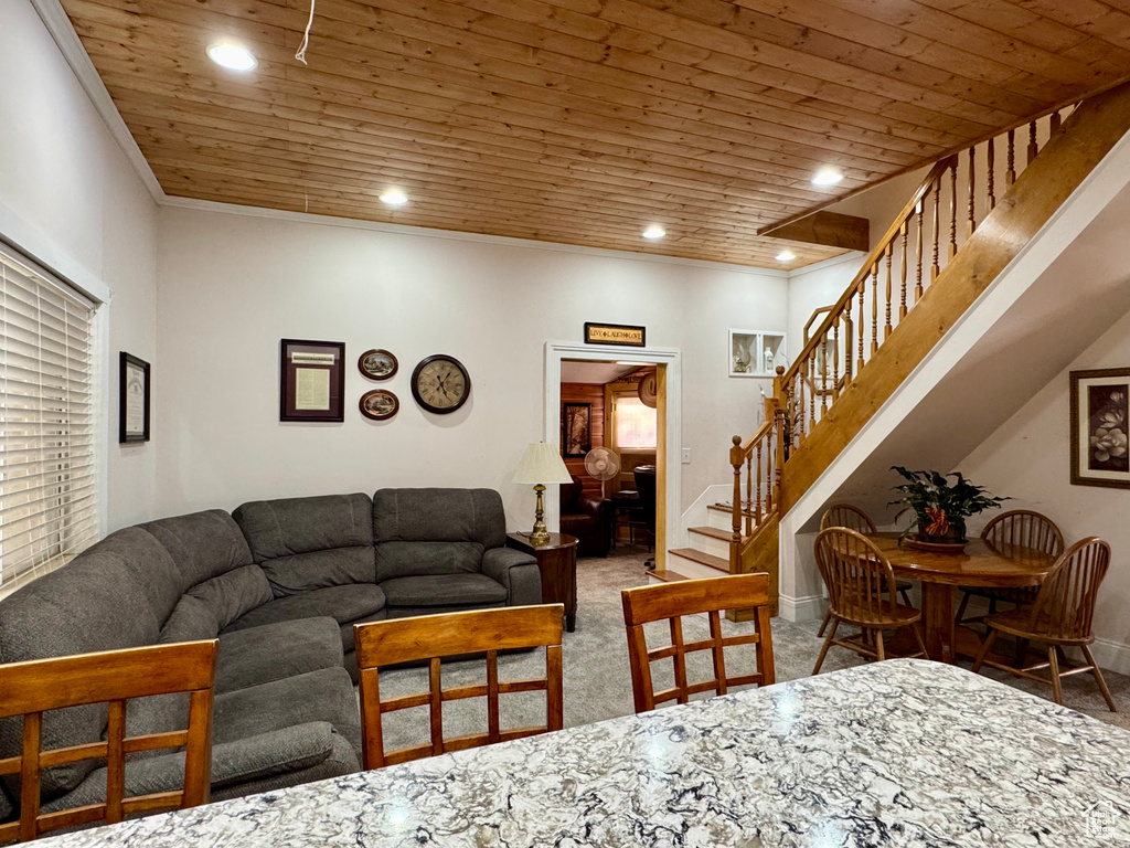 Living room featuring stairway, recessed lighting, carpet, wood ceiling, and ornamental molding