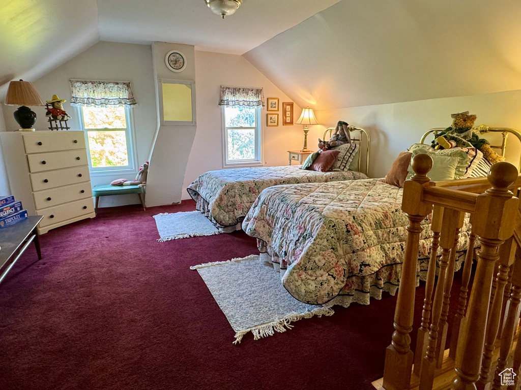 Carpeted bedroom featuring lofted ceiling