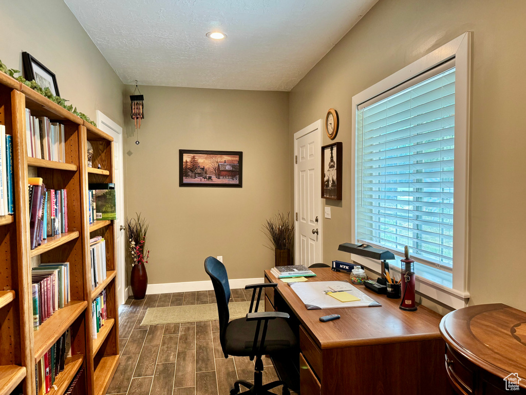 Office space featuring wood finish floors and recessed lighting