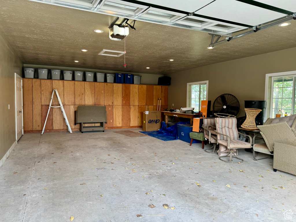Garage featuring a garage door opener and recessed lighting