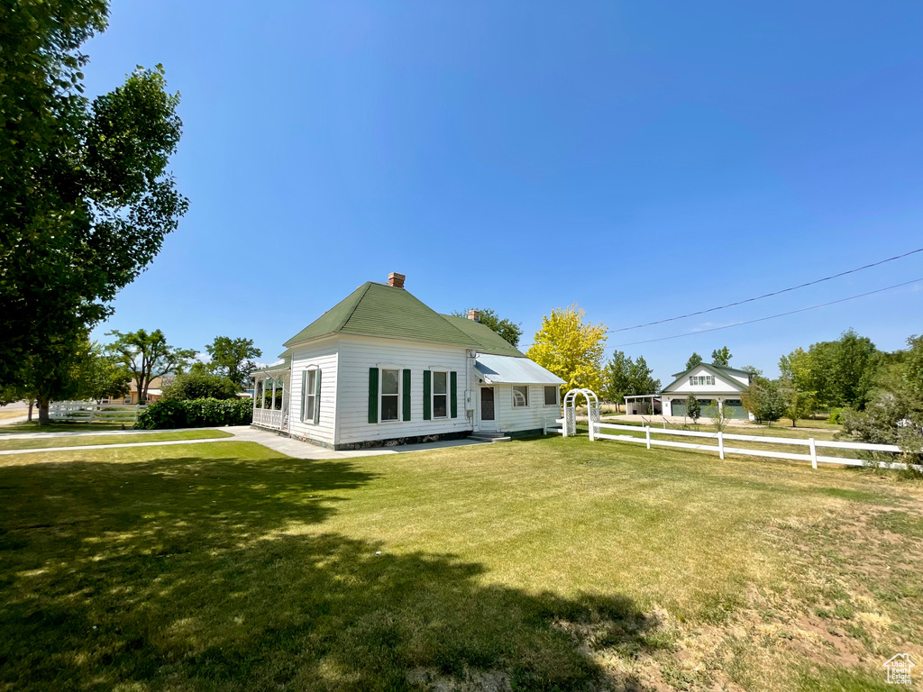 Rear view of property featuring a chimney