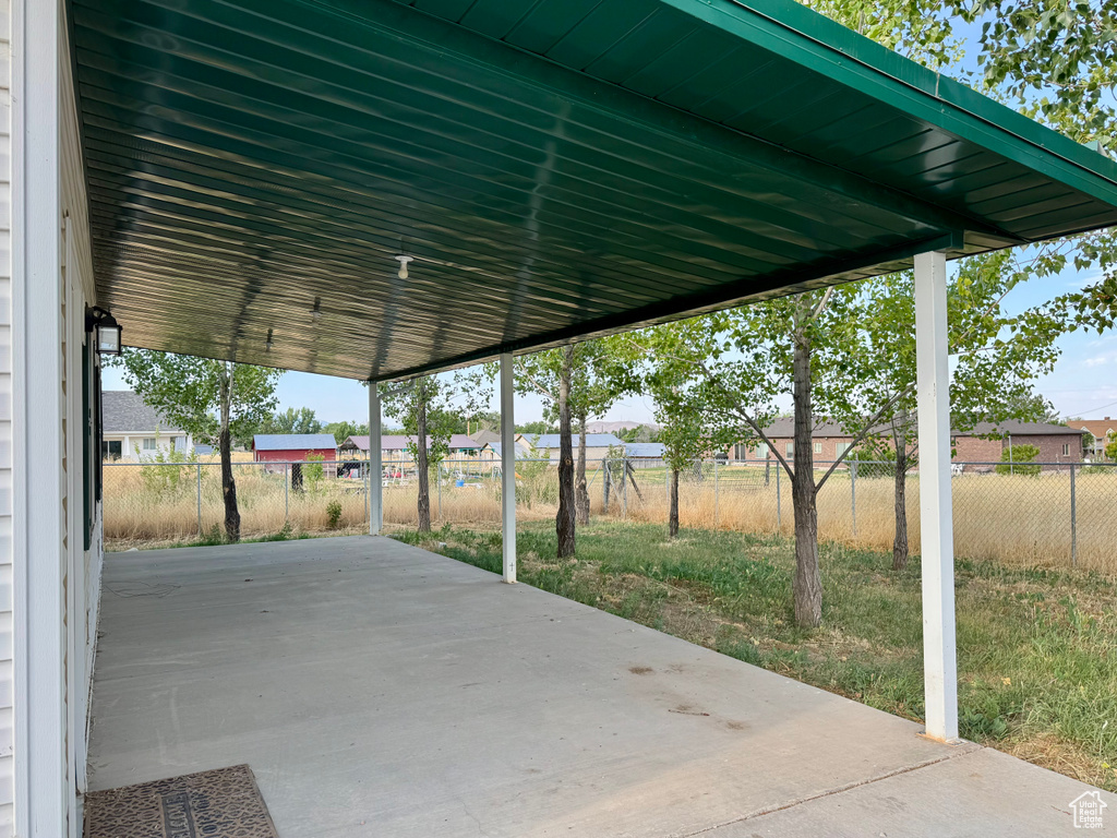 Fenced backyard with a patio area and a residential view