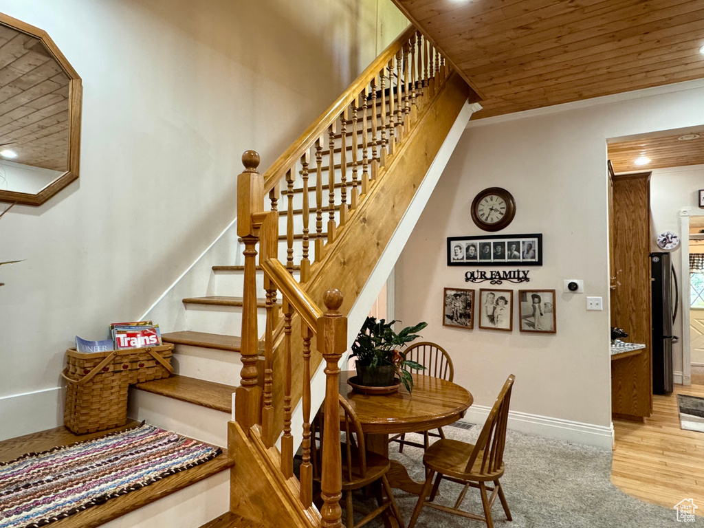Stairs featuring wood ceiling, crown molding, recessed lighting, and wood finished floors