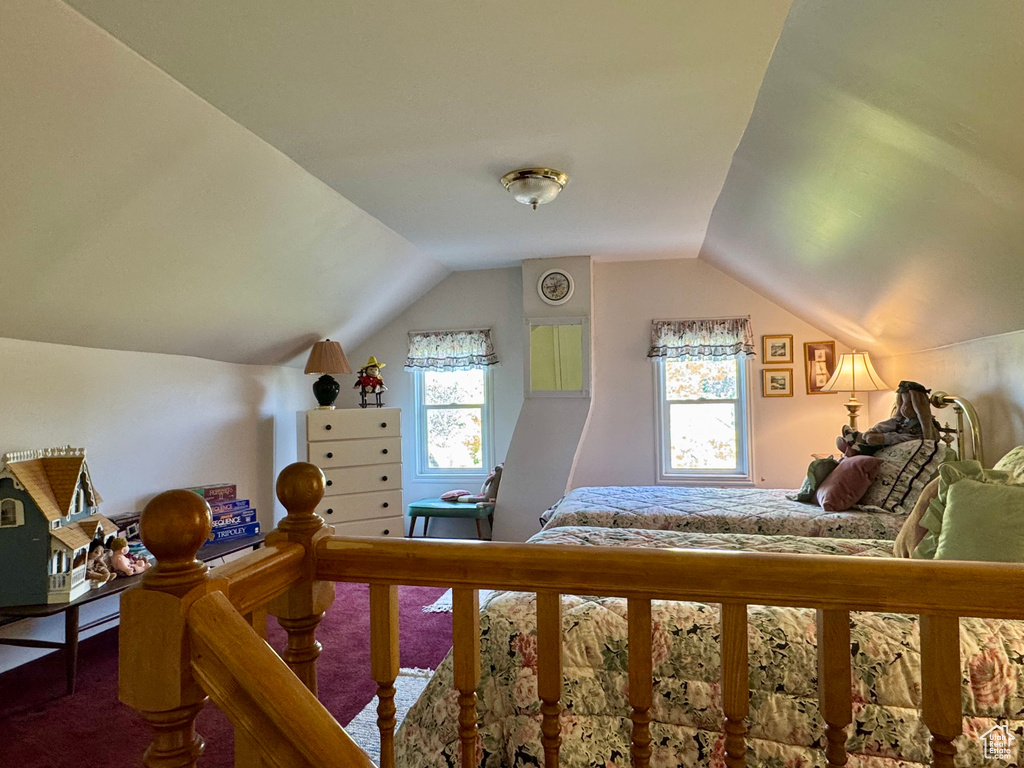 Bedroom with carpet and lofted ceiling