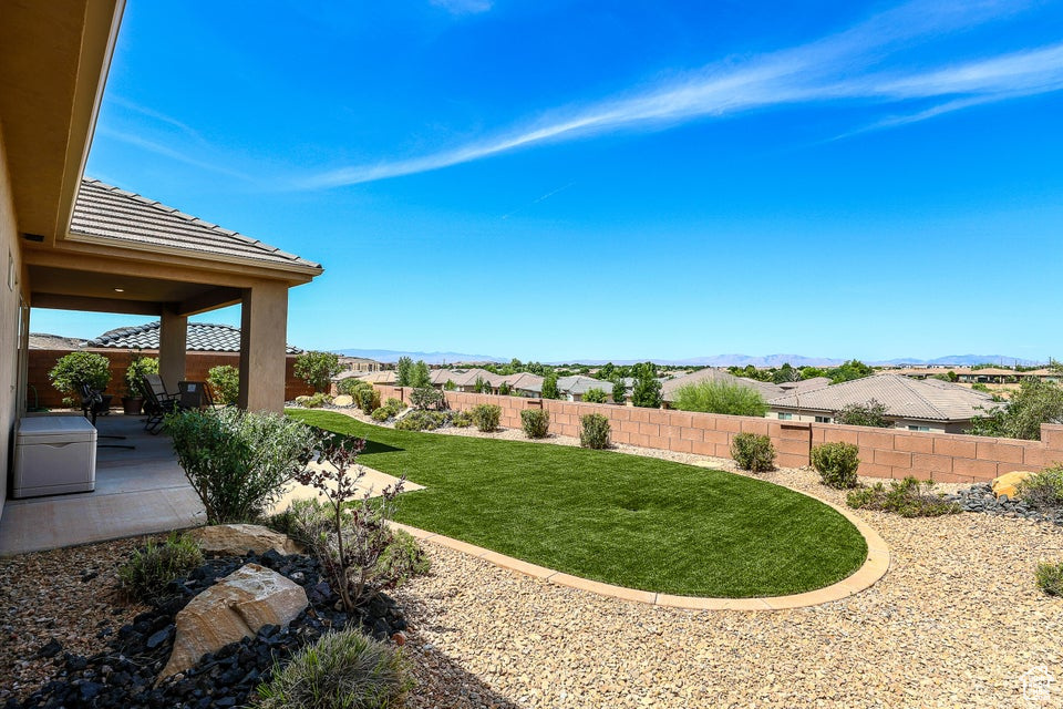 Fenced backyard with a patio and a mountain view
