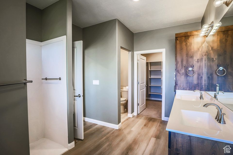 Bathroom featuring wood finished floors and double vanity