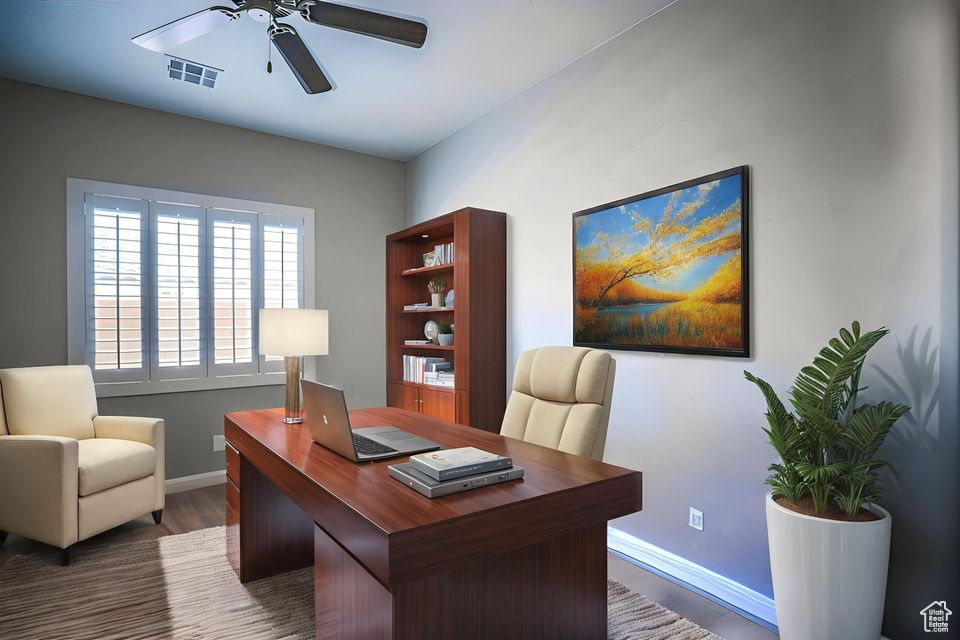 Office space featuring a ceiling fan and wood finished floors