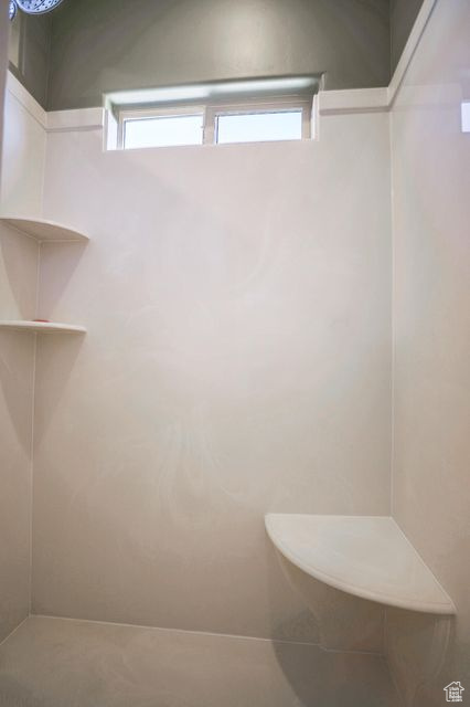 Full bathroom with healthy amount of natural light and a shower
