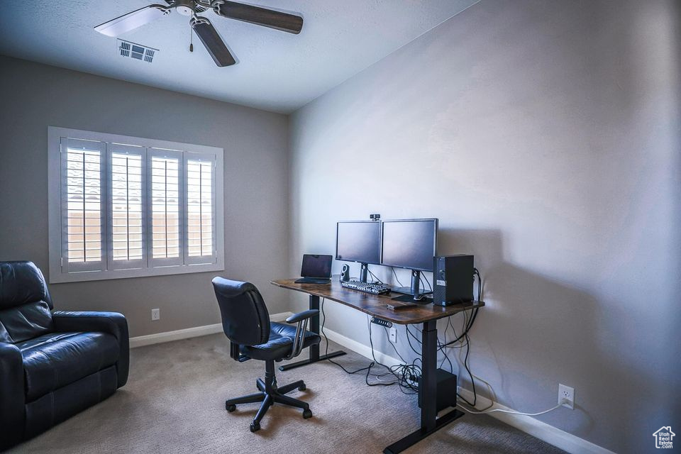 Office featuring ceiling fan and carpet