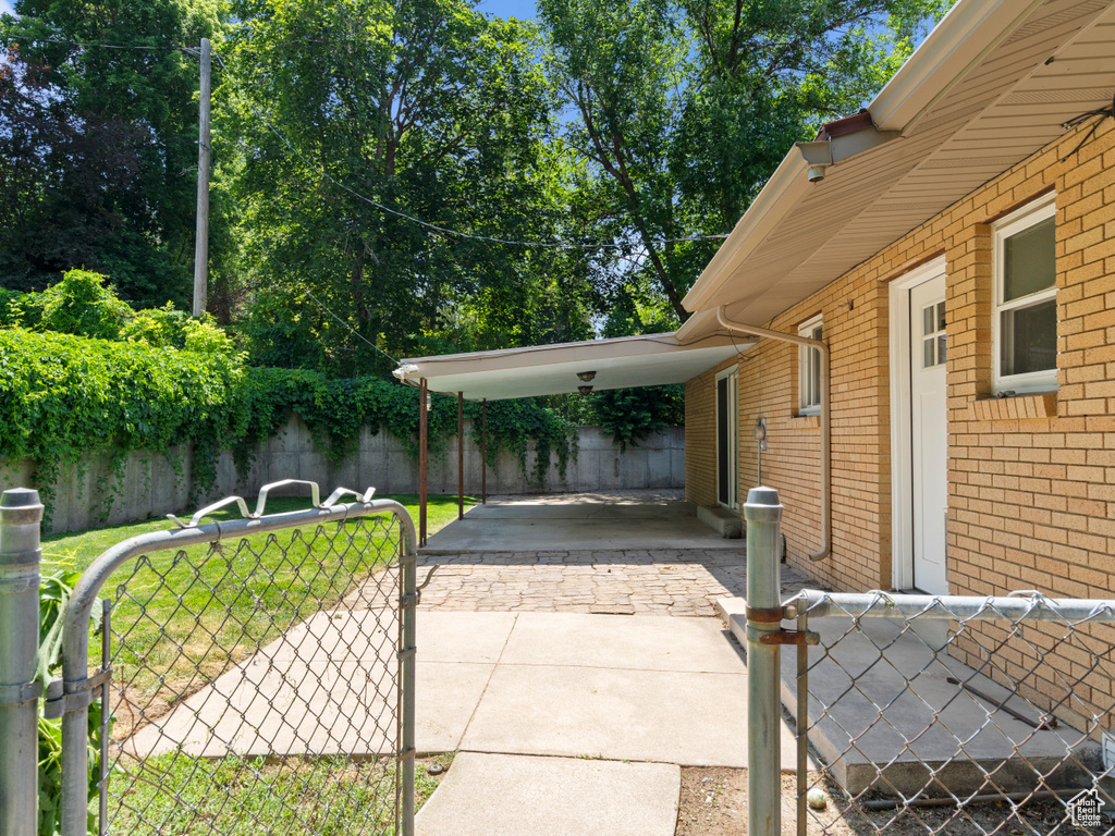 View of patio featuring a gate and a carport