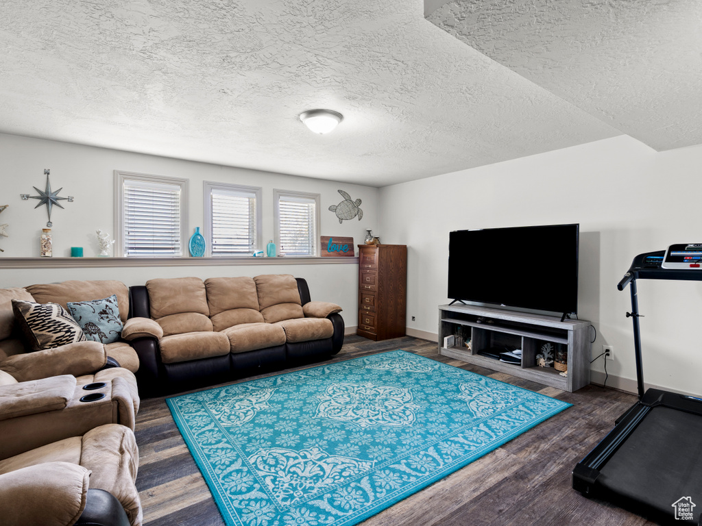 Living area featuring a textured ceiling and wood finished floors