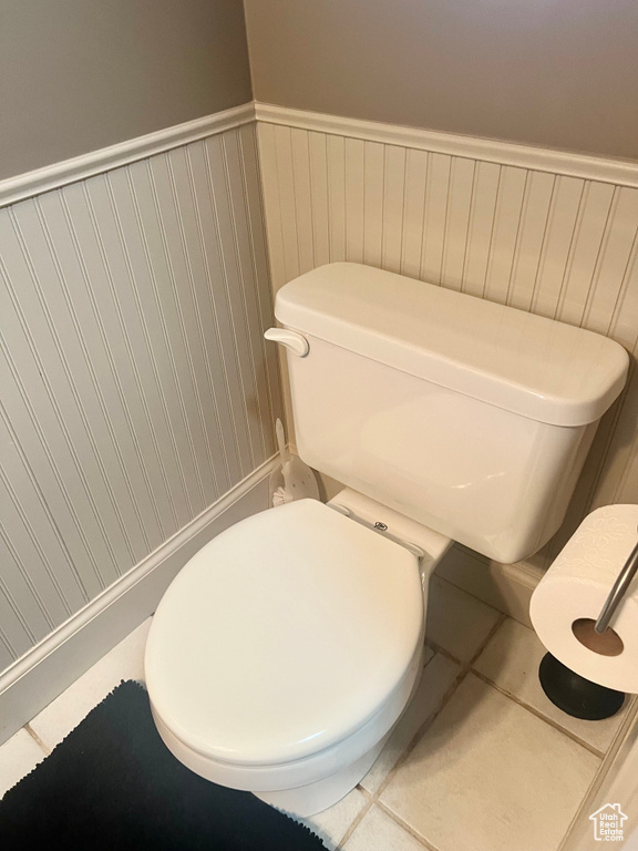Bathroom featuring tile patterned flooring and wainscoting