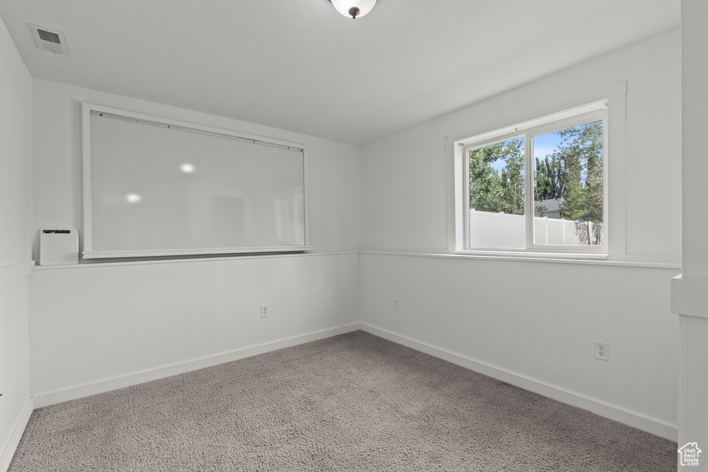 Unfurnished room featuring baseboards and carpet flooring