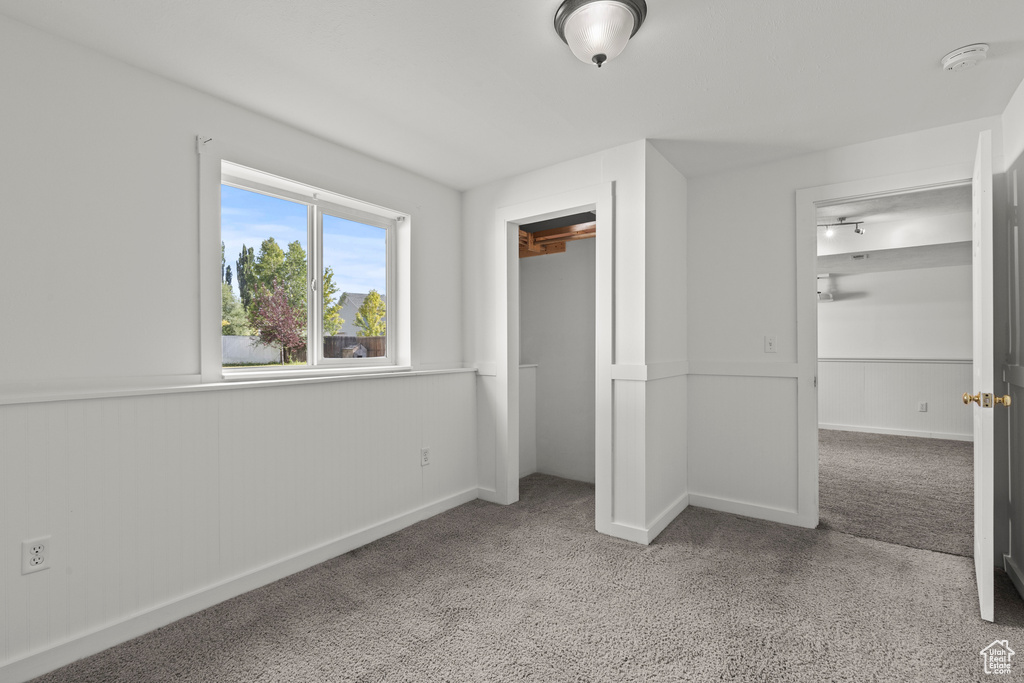 Unfurnished bedroom with carpet and a closet