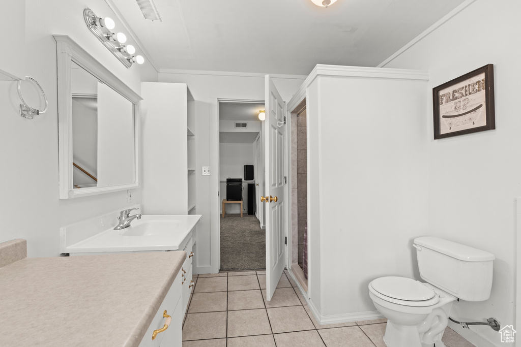 Full bathroom with vanity, tile patterned flooring, and a shower