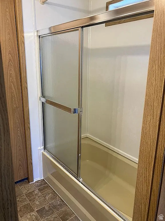 Bathroom with enclosed tub / shower combo