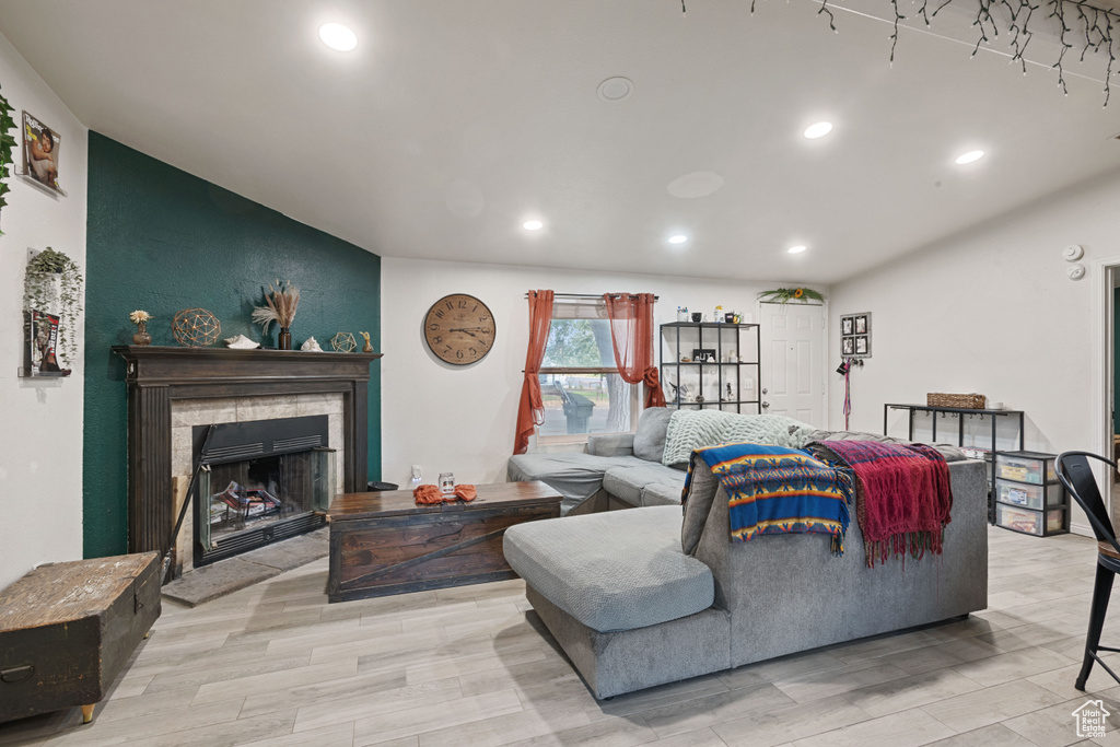 Living area with recessed lighting and a fireplace