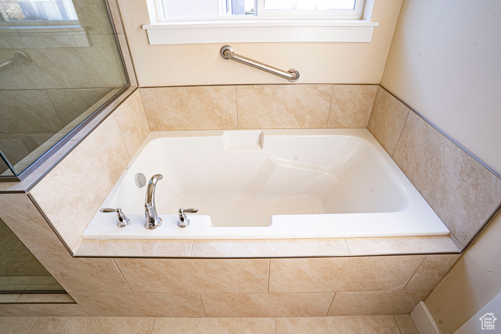 Bathroom with a garden tub and plenty of natural light
