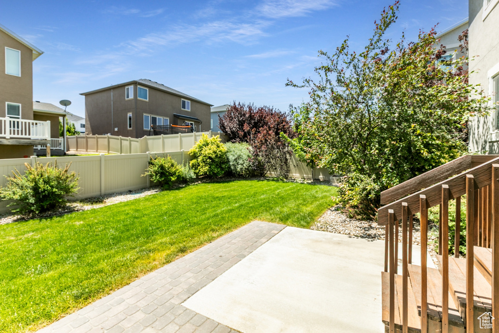 Fenced backyard with a patio and a residential view