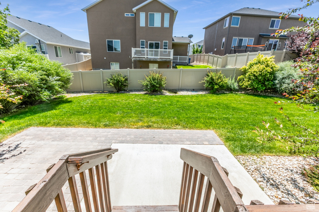 Fenced backyard featuring a patio and a residential view