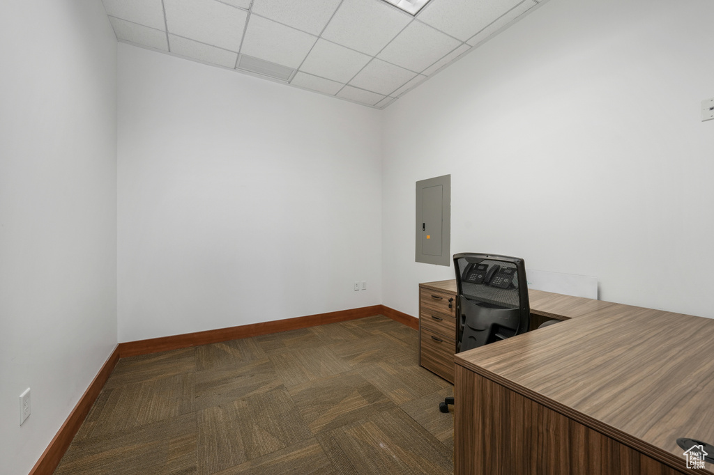 Unfurnished office with electric panel and a paneled ceiling