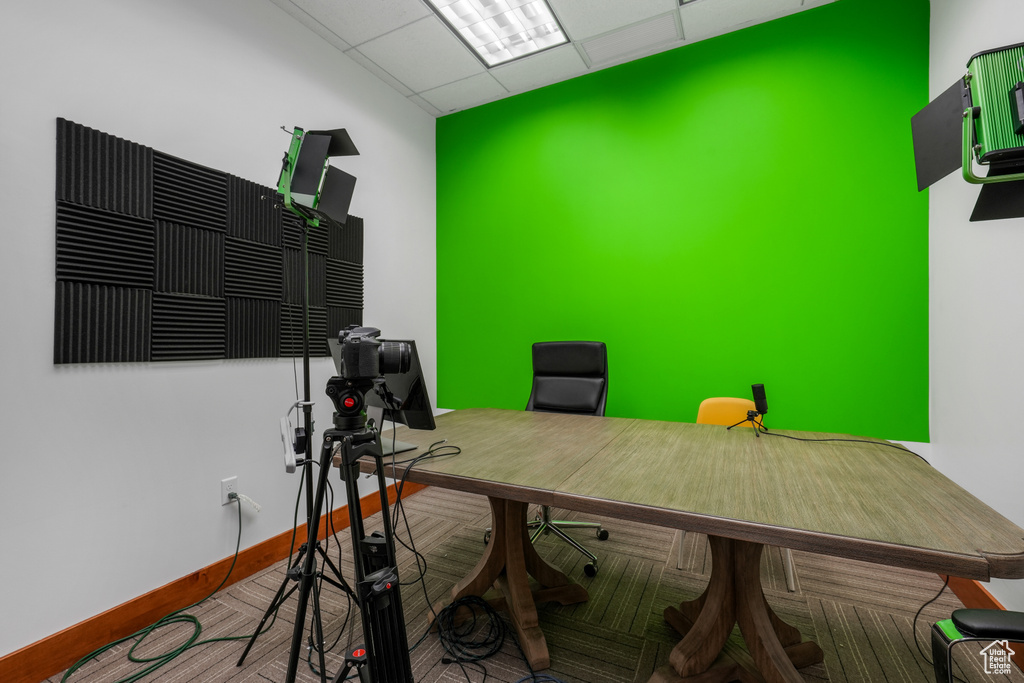 Office area with a paneled ceiling and baseboards