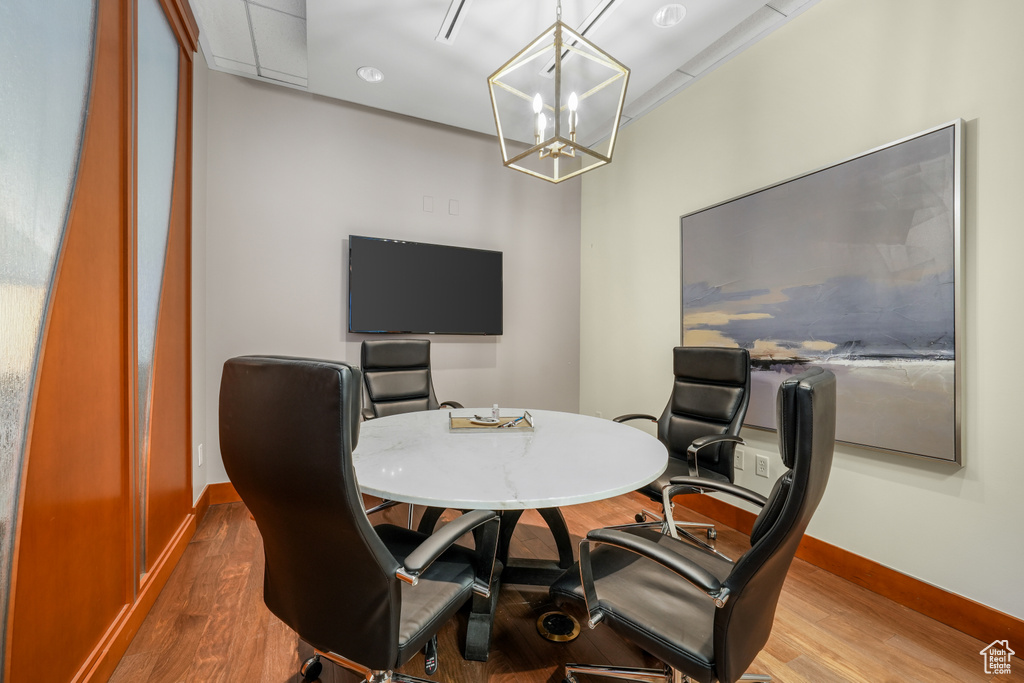 Office with wood finished floors and a chandelier