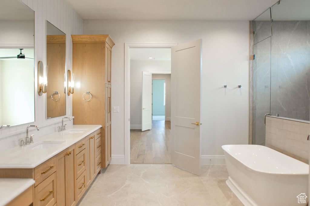 Bathroom with a freestanding tub, double vanity, and a stall shower