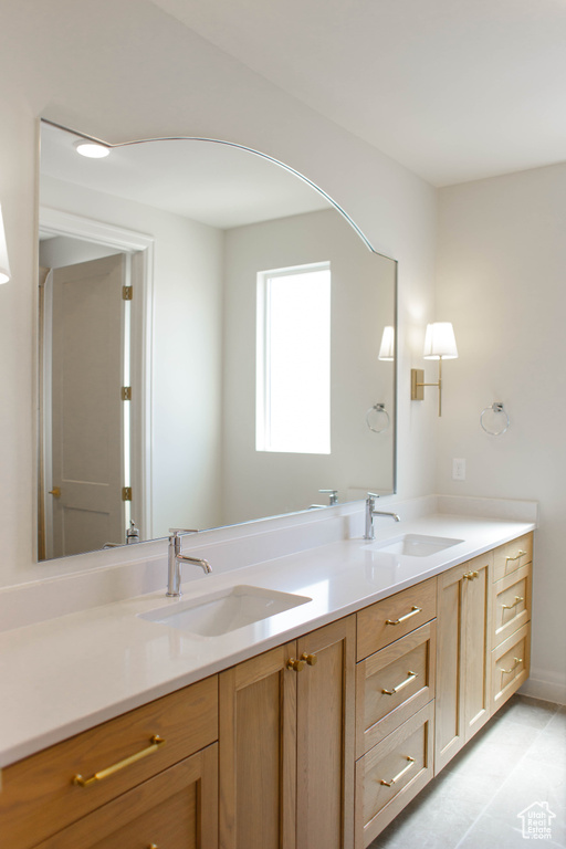Full bath featuring double vanity and tile patterned floors