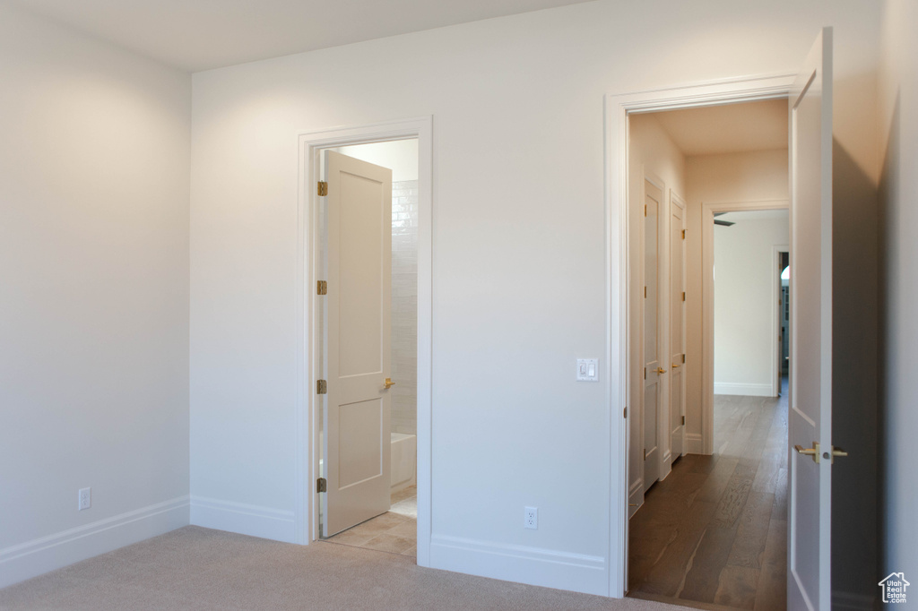 Unfurnished bedroom with baseboards and ensuite bath