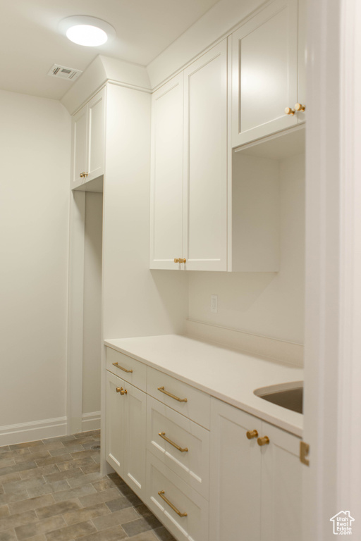 Interior space featuring white cabinetry and light countertops