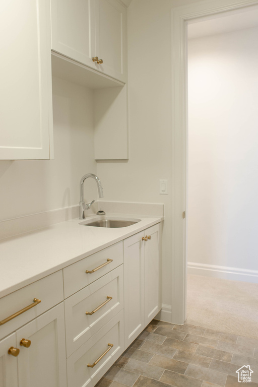 Kitchen with light countertops and white cabinetry
