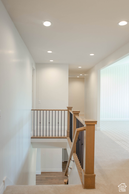 Stairway with recessed lighting and baseboards