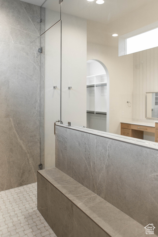Bathroom with a walk in shower, recessed lighting, and vanity