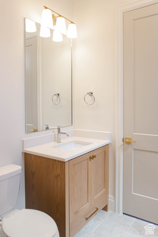 Half bathroom featuring toilet and vanity