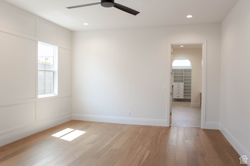 Spare room with light wood-style floors, ceiling fan, and recessed lighting