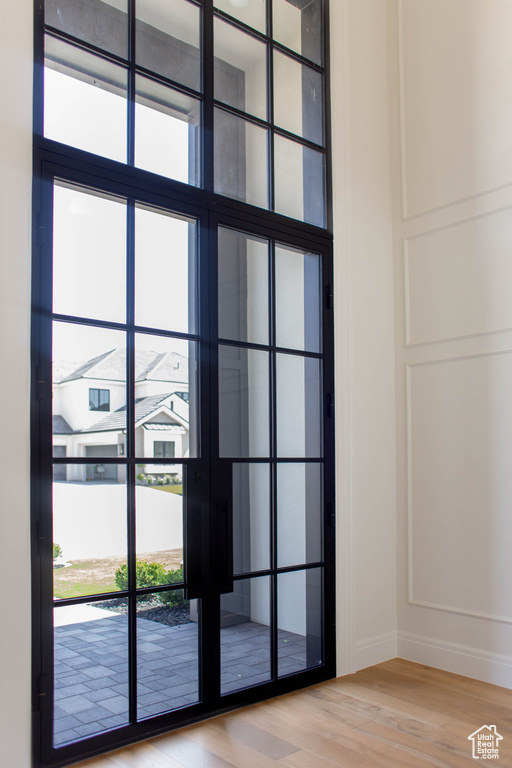 Detailed view of wood finished floors and a decorative wall