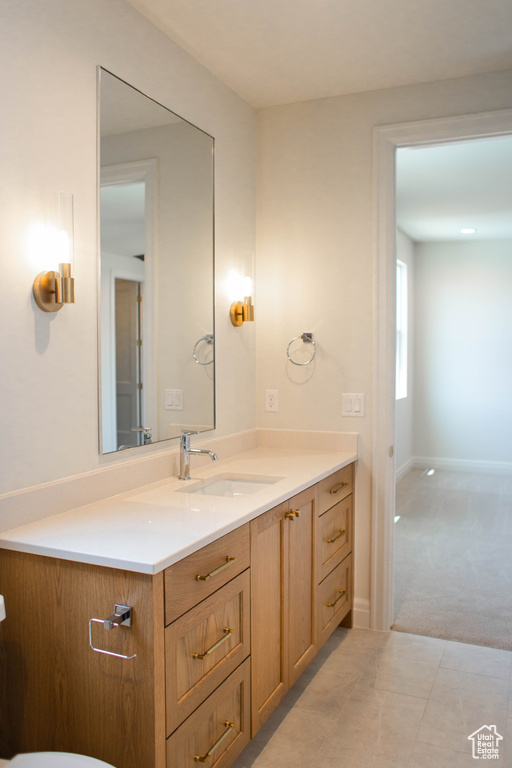 Bathroom featuring vanity and baseboards