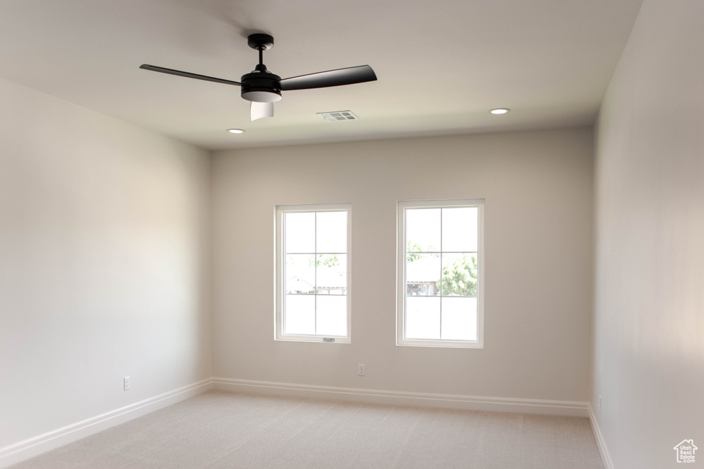 Unfurnished room featuring light colored carpet, ceiling fan, and recessed lighting