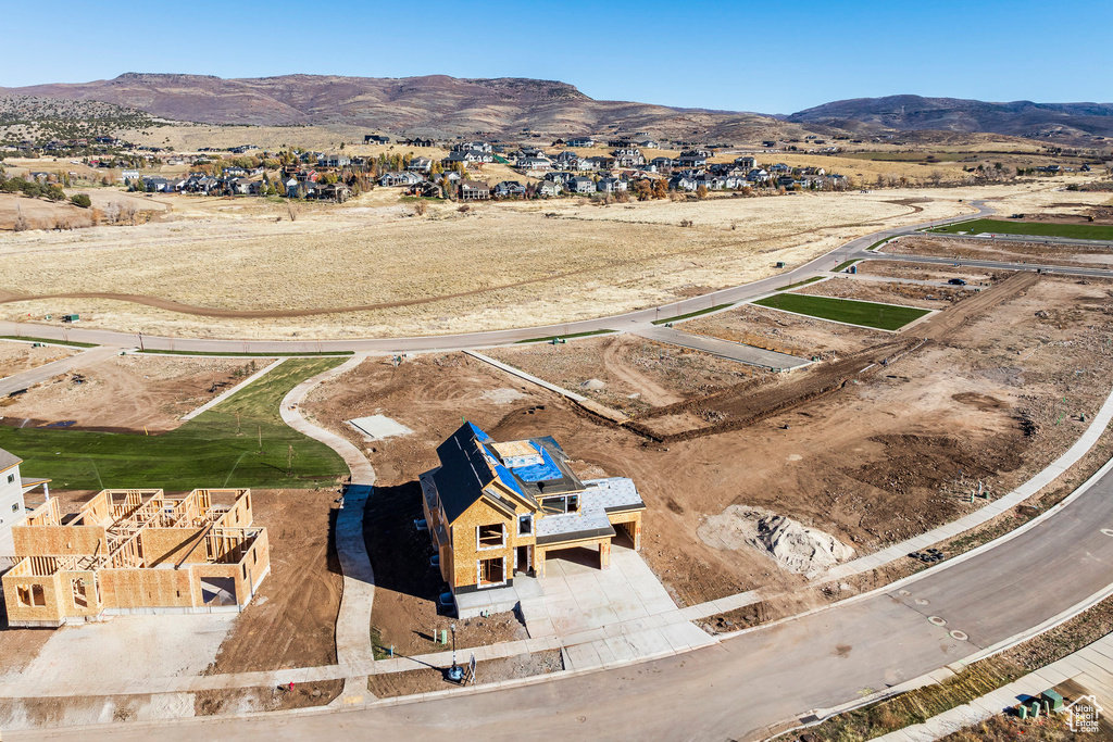 Aerial perspective of suburban area featuring a mountainous background