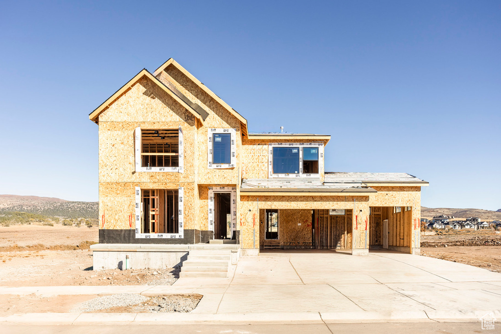 Unfinished property with a carport and driveway