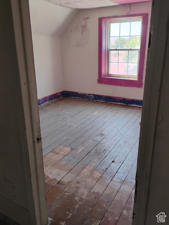 Bonus room with lofted ceiling and hardwood / wood-style floors