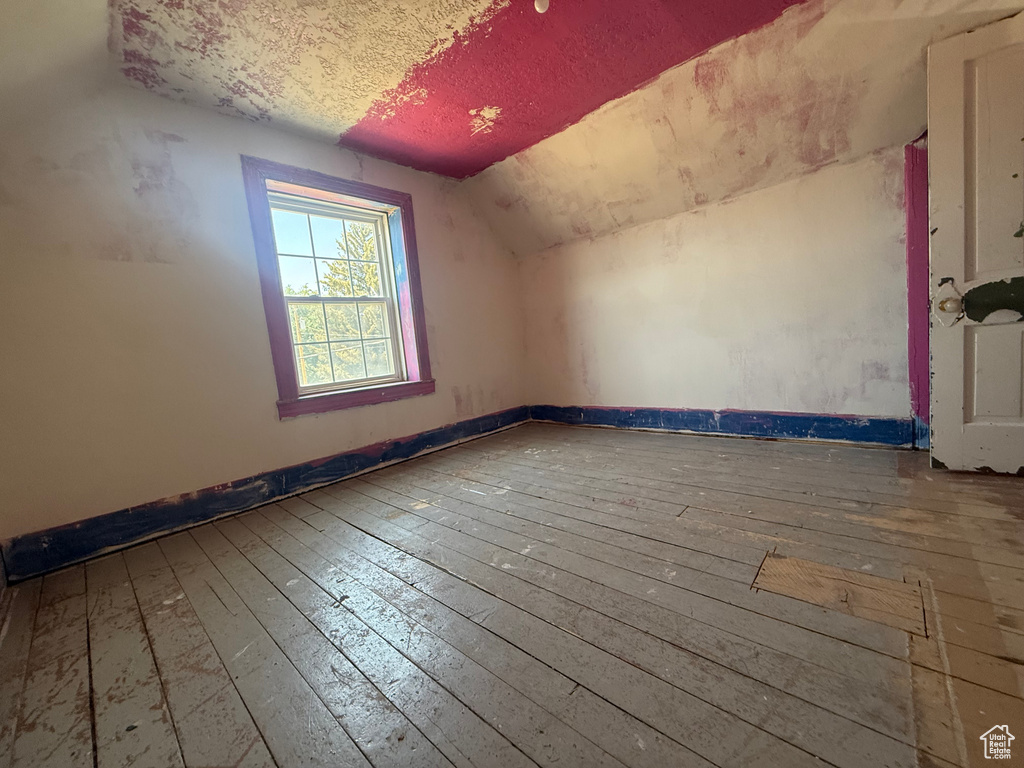 Bonus room featuring hardwood / wood-style floors and vaulted ceiling