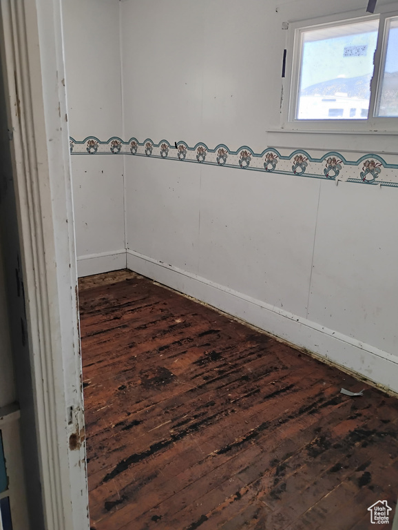 Unfurnished room with dark wood-type flooring